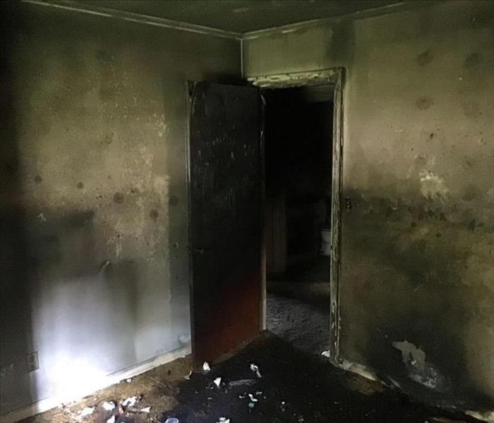 Doorway after fire burnt bedroom corner 