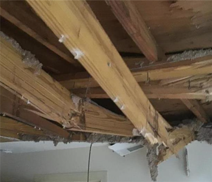 Split rafter caused by fallen tree and water damage during storm